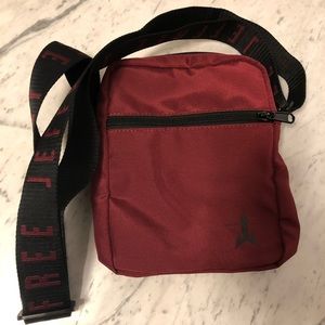 Jeffree Star burgundy and black cross bag.